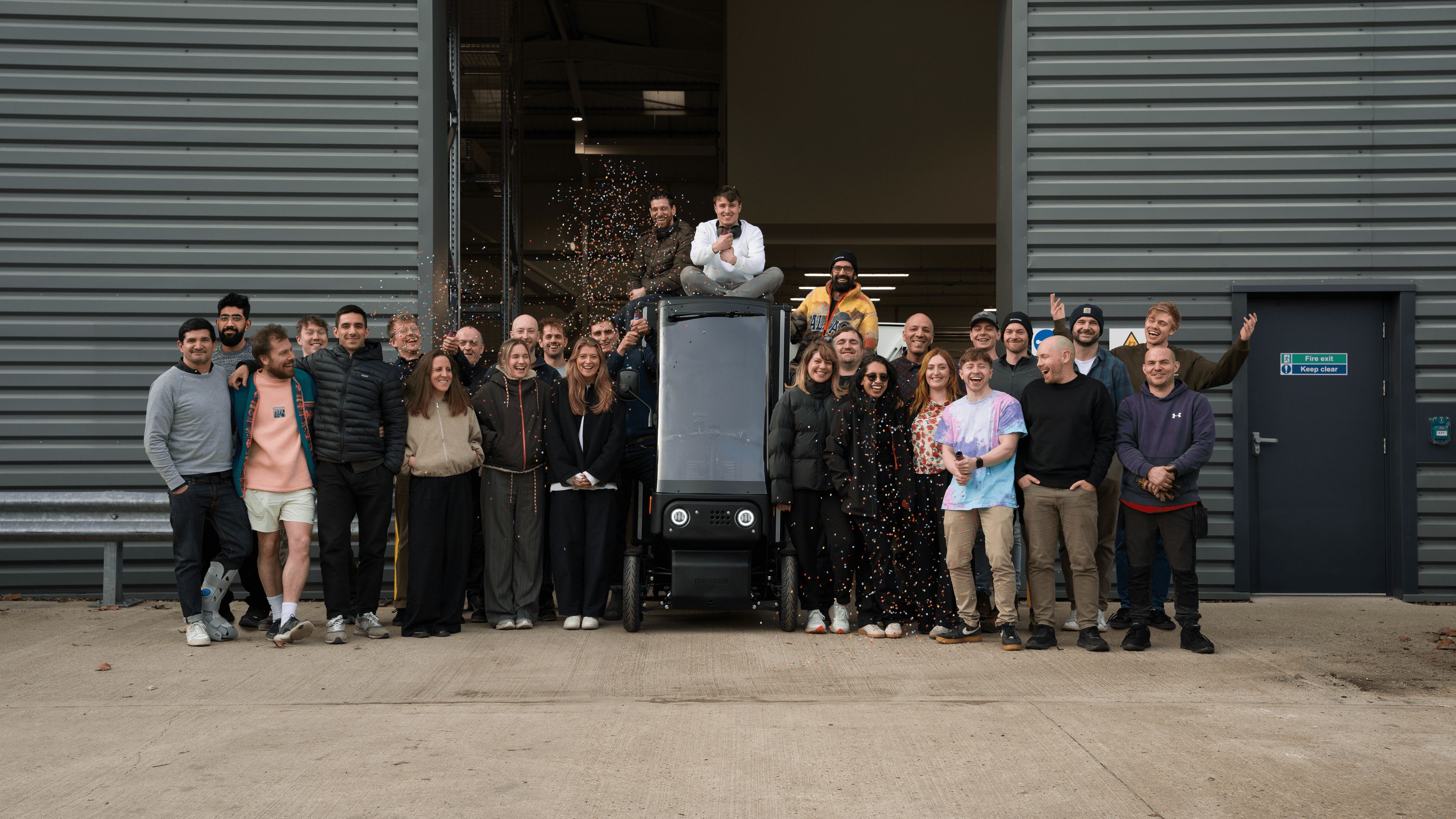 The Minimal team standing together in front of their workshop